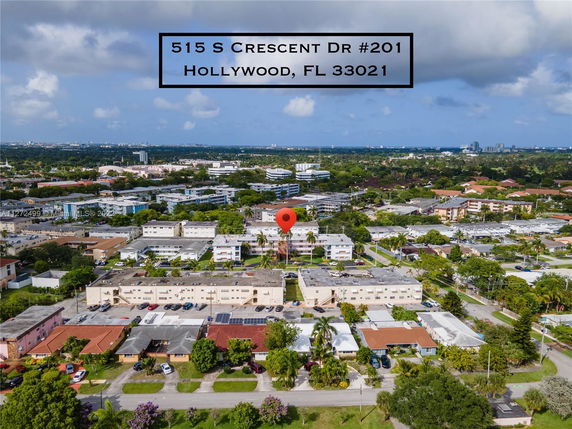 Aerial view of a residential and commercial area with multiple buildings and streets in Hollywood, FL.