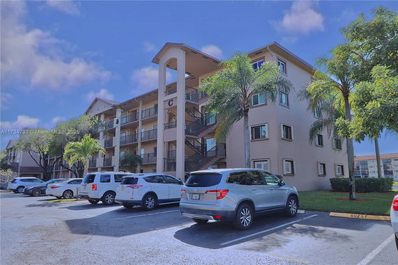 Front view of a multi-story residential building with balconies.