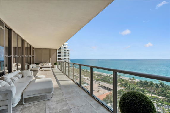 Panoramic view of the coastline and ocean from a high-rise balcony.