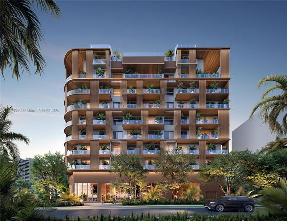 Front view of a modern multi-story building with balconies and vertical design elements.
