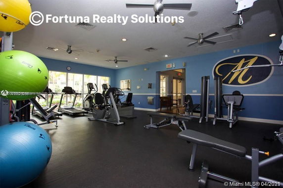 Indoor gym area with various exercise equipment and fitness balls.