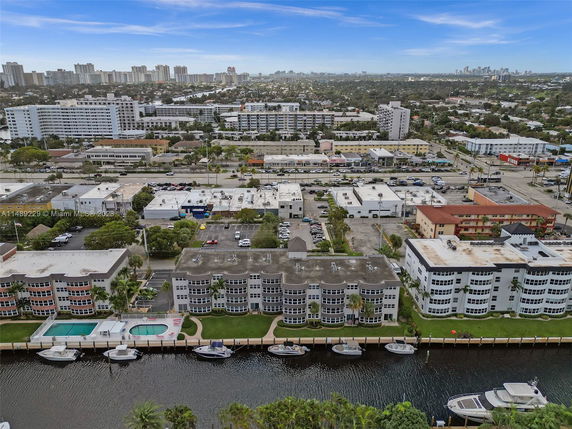 Aerial view of a residential area with multiple buildings and surrounding cityscape.