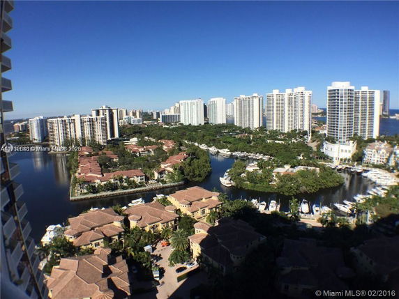 Panoramic view of a cityscape with residential and high-rise buildings near a waterway.