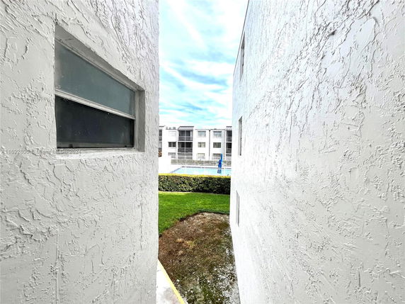 View between two buildings with a distant sight of another building.