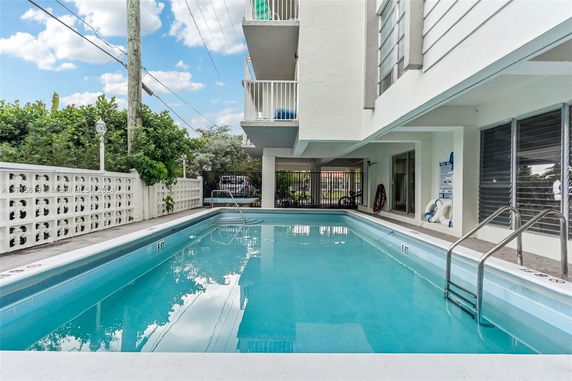 Outdoor swimming pool area adjacent to a building.