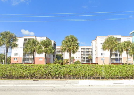 Front view of a multi-story residential building with balconies.