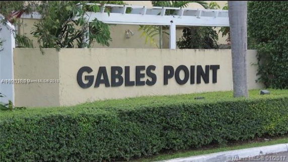 Signage for 'Gables Point' surrounded by greenery.