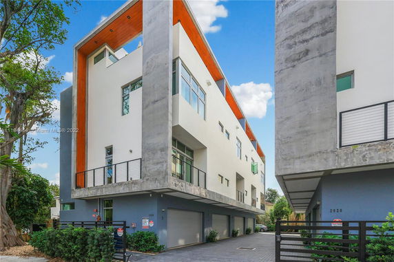 Front view of a multi-story modern building with balconies.