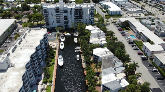 Aerial view of apartment buildings and a canal with boats.
