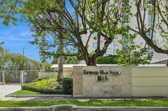 Front view of a modern building with the name Grove Harbour displayed on a stone wall.
