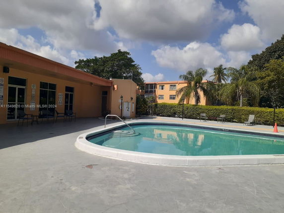 Outdoor area with a swimming pool next to a building.