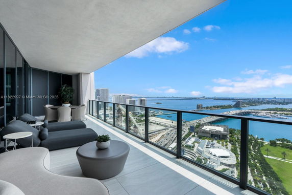 Balcony view overlooking the cityscape and waterfront from a high-rise building.