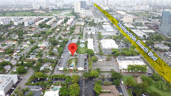 Aerial view of a residential area with roads and buildings.