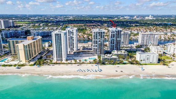 Aerial view of high-rise buildings along a beachfront area.