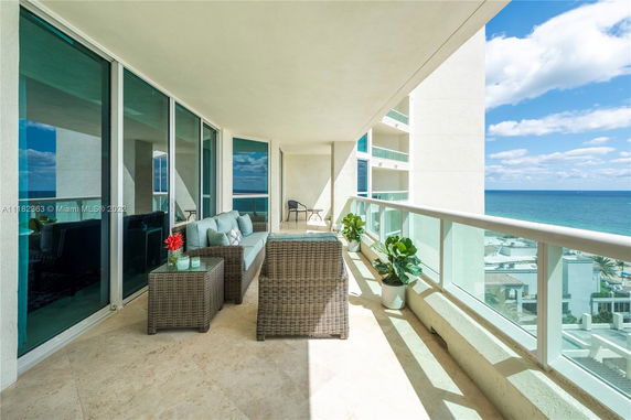 Balcony view with ocean in the background from a residential building.
