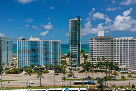 View of multiple high-rise buildings with the ocean in the background.