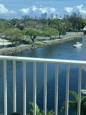 Panoramic view of a city skyline and river from a balcony.