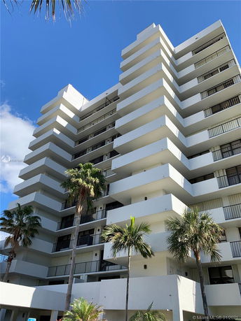 Front view of a multi-story residential building with balconies.