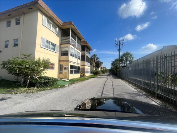 Front view of a three-story residential building with balconies.