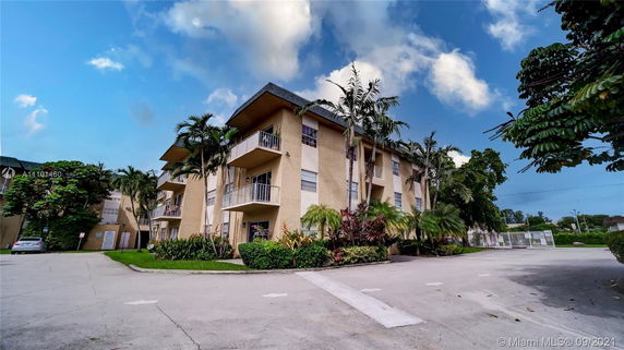 Front view of a multi-story residential building with balconies.