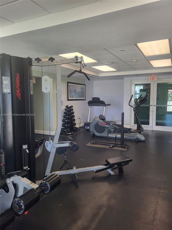 Indoor gym with exercise equipment and machines.