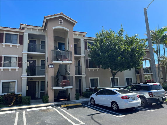 Front view of a multi-story residential building with balconies.
