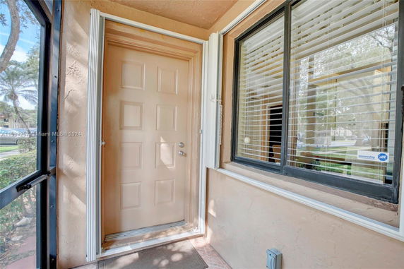 Front view of a house entrance with a door and window.