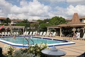 Outdoor swimming pool area with lounge chairs and a shaded cabana.