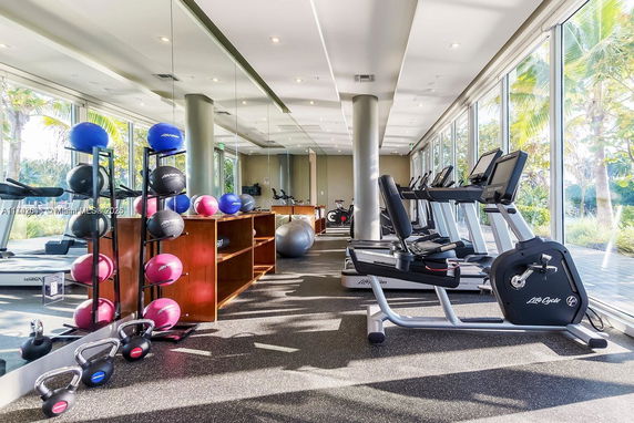 Indoor gym area with exercise equipment and mirrors.
