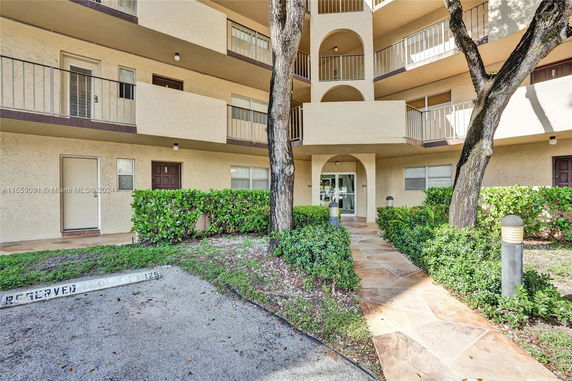Front view of a multi-story apartment building with balconies.