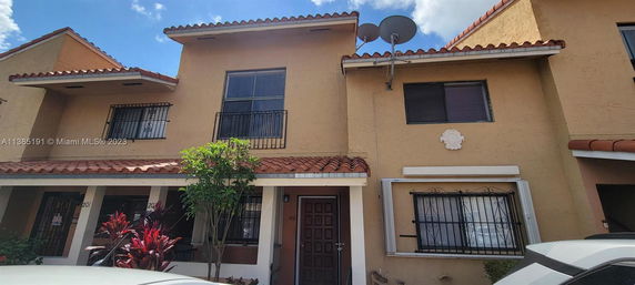 Front view of a townhouse with a two-story design and a tiled roof.