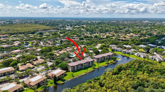 Aerial view of residential buildings and surrounding greenery.