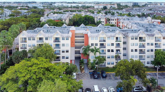 Front view of a multi-story apartment building with gabled roofs.
