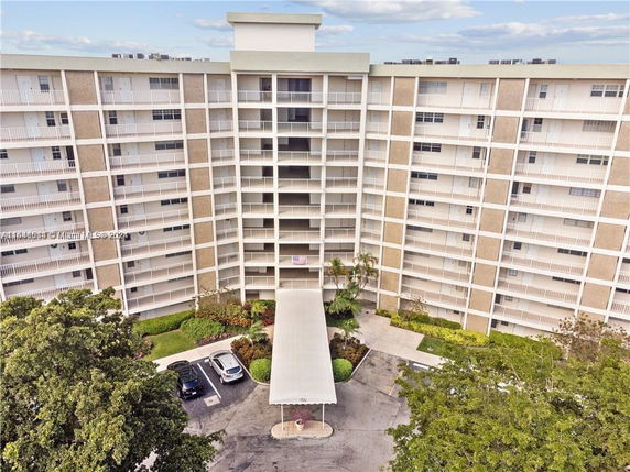 Front view of a multi-story residential building with a covered entrance.