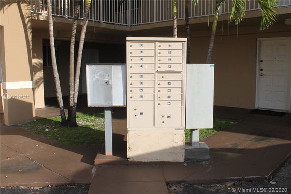 Front view of a building with mailboxes outside.