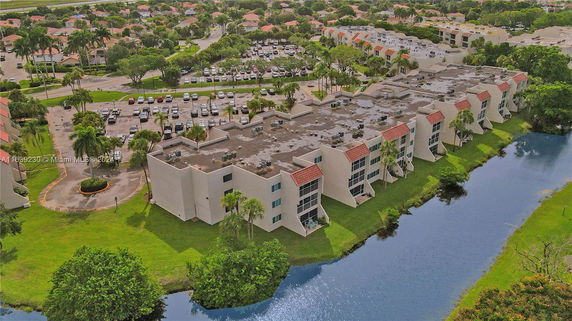 Aerial view of multi-story residential buildings with flat rooftops featuring various mechanical units and equipment.
