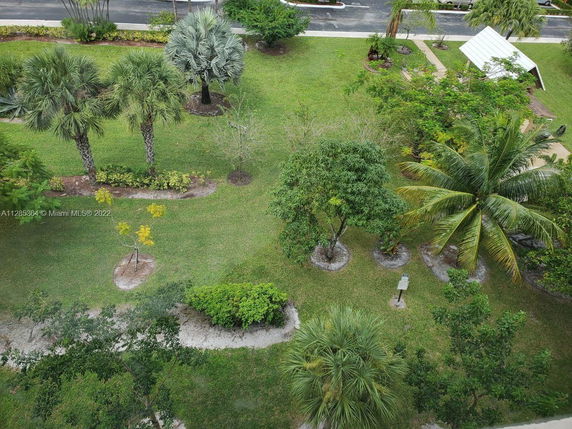 Aerial view of a landscaped garden with various trees and pathways.
