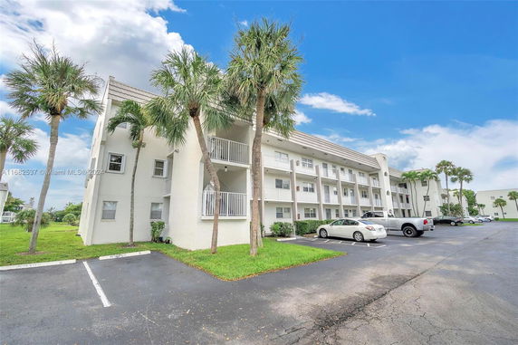 Front view of a multi-story residential building with balconies.