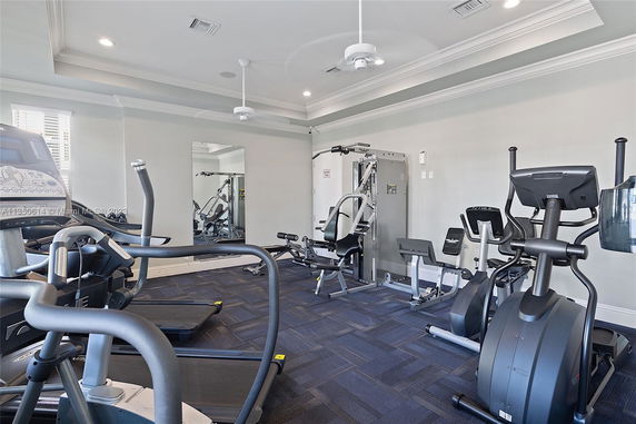 Indoor gym area with exercise machines and workout equipment.