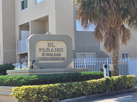 Front view of a condominium with a sign reading 'El Paraiso @ Hialeah Condominium'.
