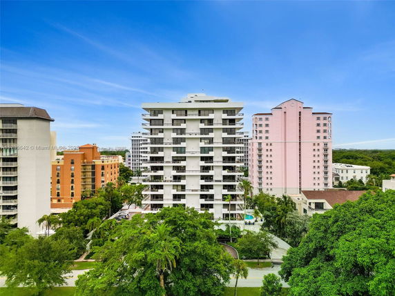 Front view of a multi-story residential building with balconies.
