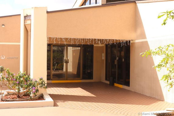 Front view of a building with a glass door entrance and decorative lights.