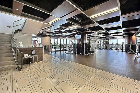 Interior view of a modern gym with various exercise equipment.