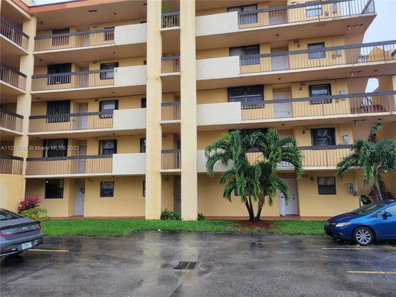 Front view of a multi-story residential building with balconies.