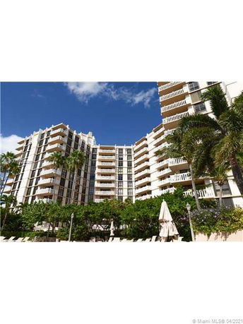 Front view of a multi-story residential building with balconies.