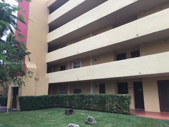 Front view of a multi-story residential building with balconies.