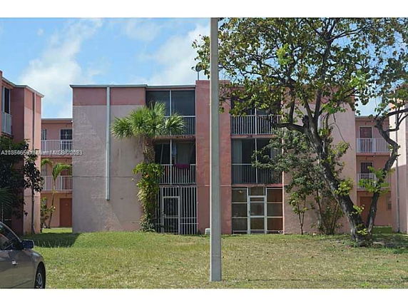 Front view of a multi-story residential building with balconies.