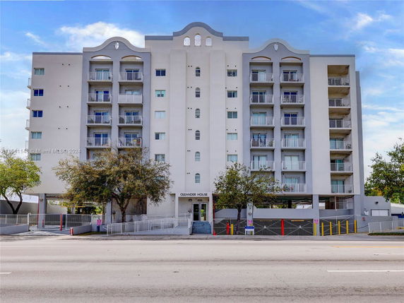 Front view of a multi-story residential building with balconies.