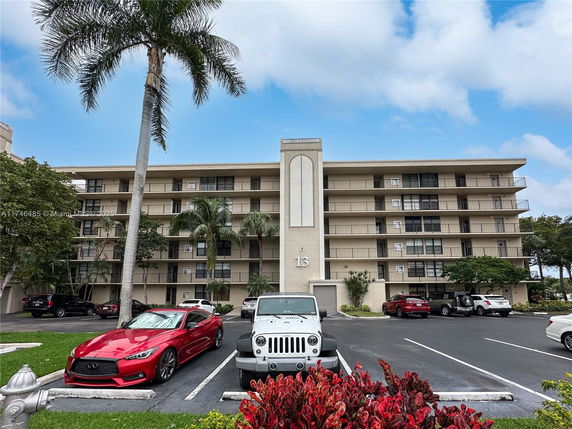 Front view of a multi-story apartment building with balconies.