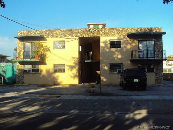 Front view of a two-story residential building with stone accents.